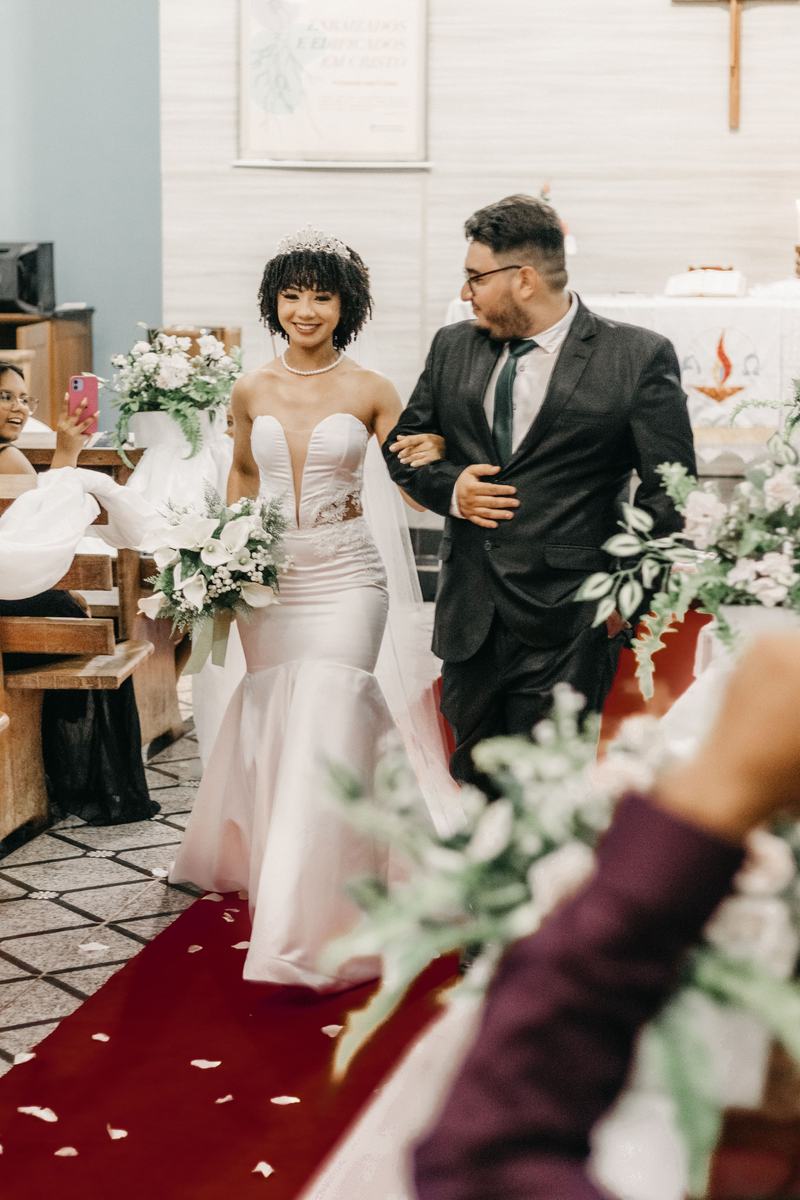 Bride and groom walking arm in arm at the reception